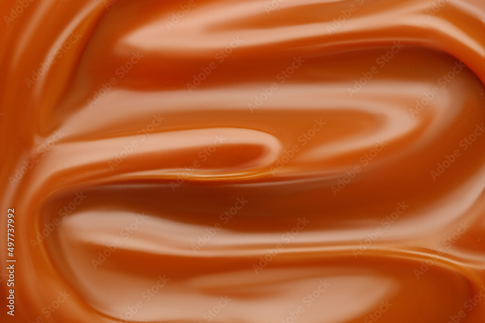 Liquid caramel syrup. Background of caramel paste. Texture Close up, top view. Liquid caramel syrup. Background of caramel paste. Texture Close up, top view.