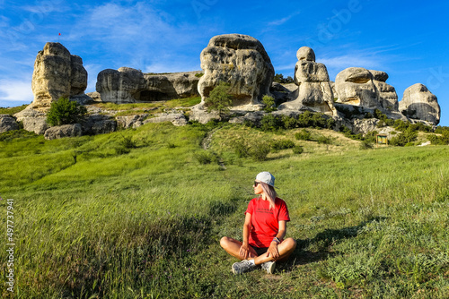 A girl on the background of a picturesque view of the Bakhchisarai sphinxes in summer. Bakhchisarai. May 2021. Crimea. photo