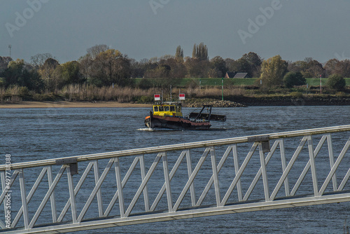 tugboat cleans the bottom of the river Rhine near Lobith-Tolkamer