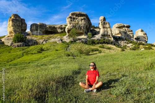 A girl on the background of a picturesque view of the Bakhchisarai sphinxes in summer. Bakhchisarai. May 2021. Crimea. photo