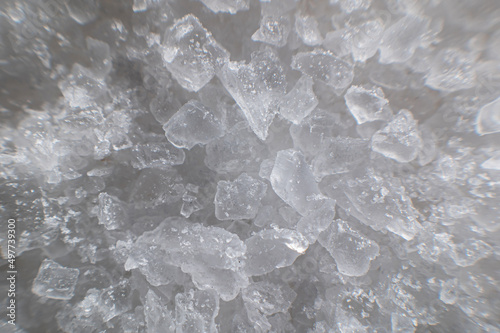 Coarse white iodized salt. Detailed background texture Macro close-up. Salt crystals of different sizes