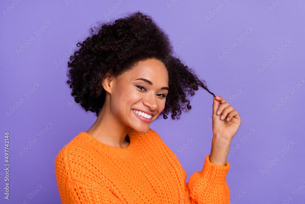 Portrait of attractive cheerful cute girl touching curls good mood isolated over bright purple violet color background Portrait of attractive cheerful cute girl touching curls good mood isolated over bright purple violet color background