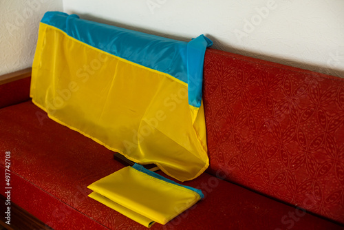 A folded Ukrainian flag lying on the couch photo