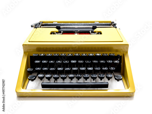 Vintage mustard yellow typewriter on a white background