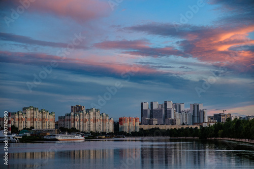 MOSCOW, RUSSIA - AUGUST 5, 2018: View of modern buildings near the water during sunset © irimeiff