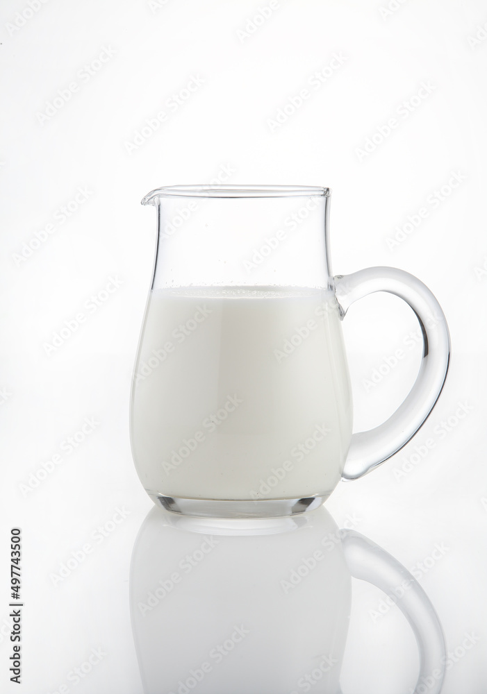 Natural whole milk in a jug isolated on a white background Natural whole milk in a jug isolated on a white background
