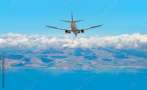 Airplane landing to airport runway Blue sea and dense clouds in the background