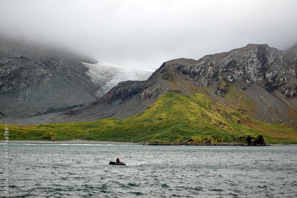 Glacier between two hills, under low hanging clouds, at Coopers Bay, South Georgia Island Glacier between two hills, under low hanging clouds, at Coopers Bay, South Georgia Island