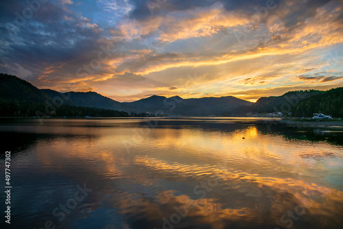 Reflections of sunset and clouds on a lake