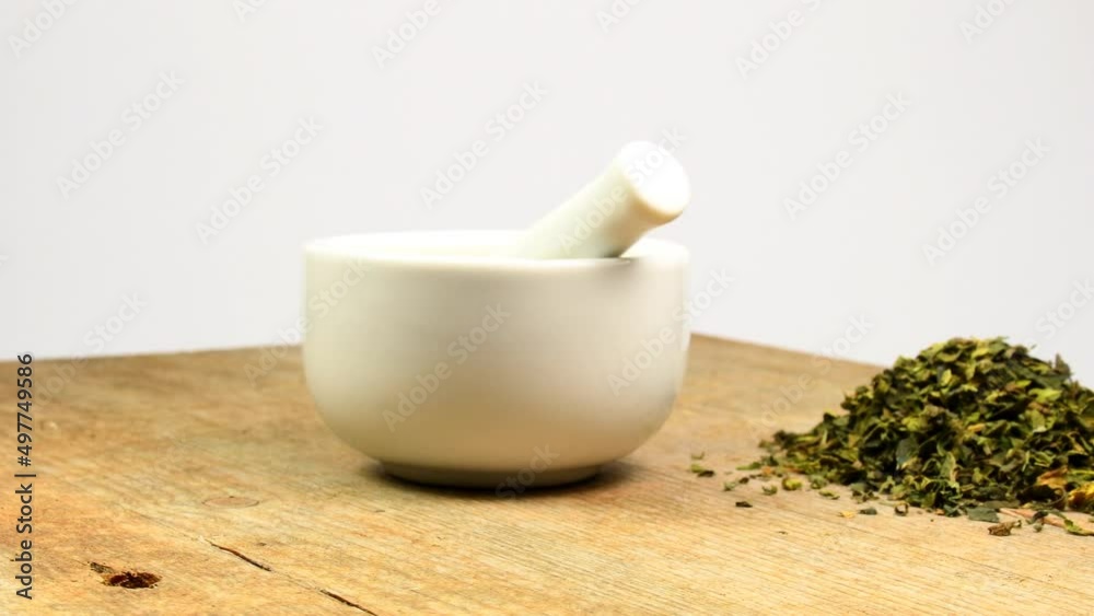 mortar and dried herb of stinging nettle on a turn table mortar and dried herb of stinging nettle on a turn table