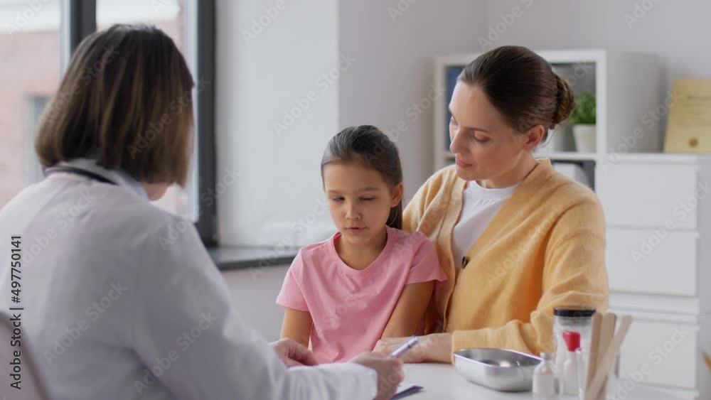 medicine, healthcare and pediatry concept - mother with little daughter talking toi doctor at clinic medicine, healthcare and pediatry concept - mother with little daughter talking toi doctor at clinic