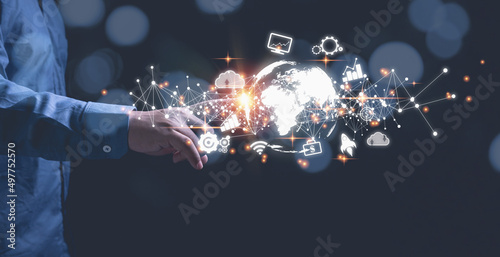 Businessman touching earth virtual world have internet networks online, and business icons with copy space black background. Technology information and transformation business concept. photo