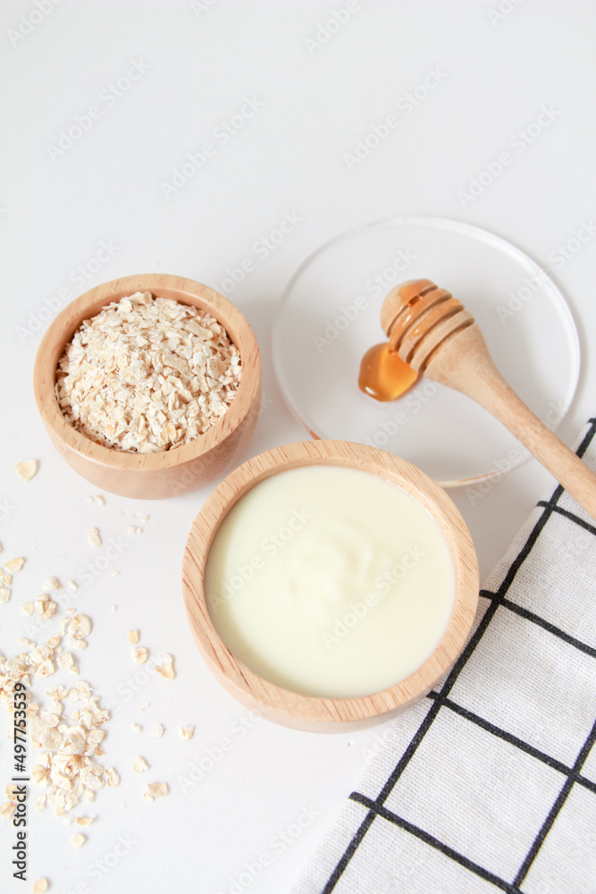Natural ingredients for homemade face mask, top view of yoghurt, oat and honey on white background, beauty skincare product concept, flat lay Natural ingredients for homemade face mask, top view of yoghurt, oat and honey on white background, beauty skincare product concept, flat lay
