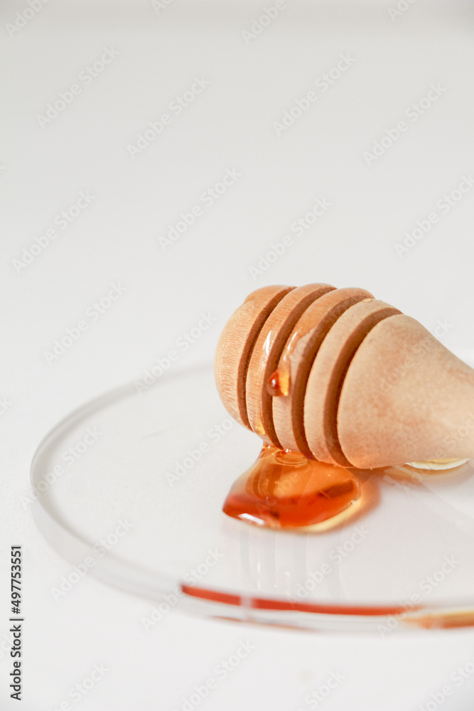 Honey scoop wooden spoon on clear acrylic. Honey scoop wooden spoon on clear acrylic.