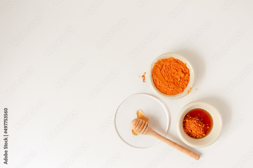 Natural ingredients for homemade face mask, top view of turmeric and honey on white background, beauty skincare product concept, flat lay Natural ingredients for homemade face mask, top view of turmeric and honey on white background, beauty skincare product concept, flat lay