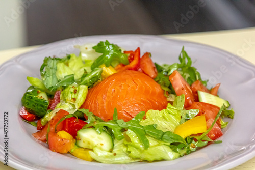 Salad with salmon, cucumbers, tomatoes and beets