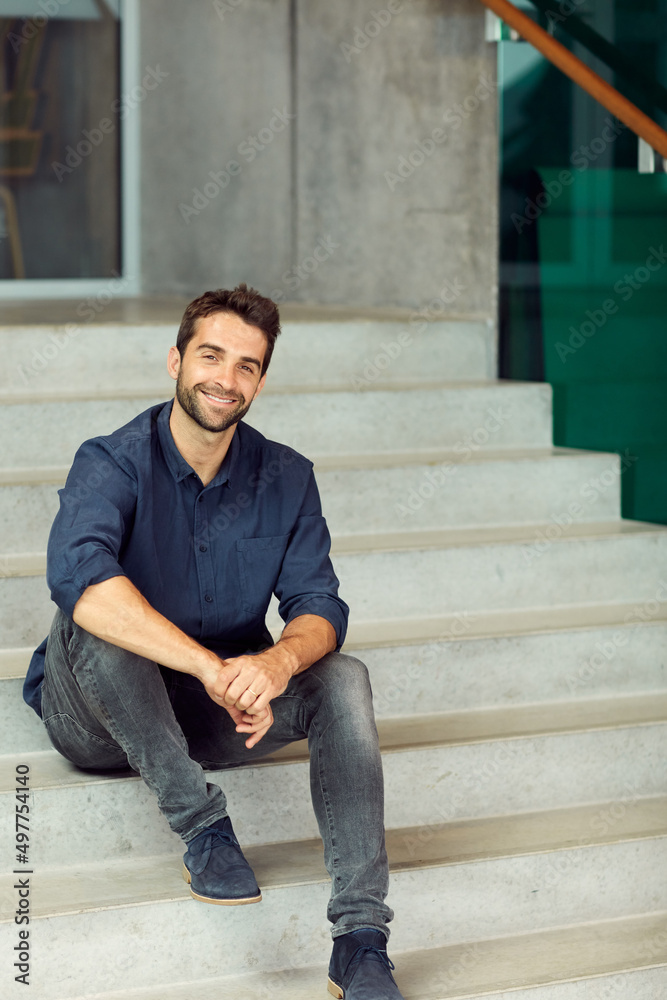 Being an entrepreneur takes passion. Cropped portrait of a handsome young businessman sitting alone on a staircase during the day. Being an entrepreneur takes passion. Cropped portrait of a handsome young businessman sitting alone on a staircase during the day.