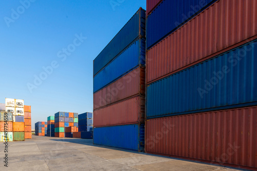 Stack of containers in a harbor. Shipping containers stacked on cargo ship. Background of Stack of Containers at a Port.