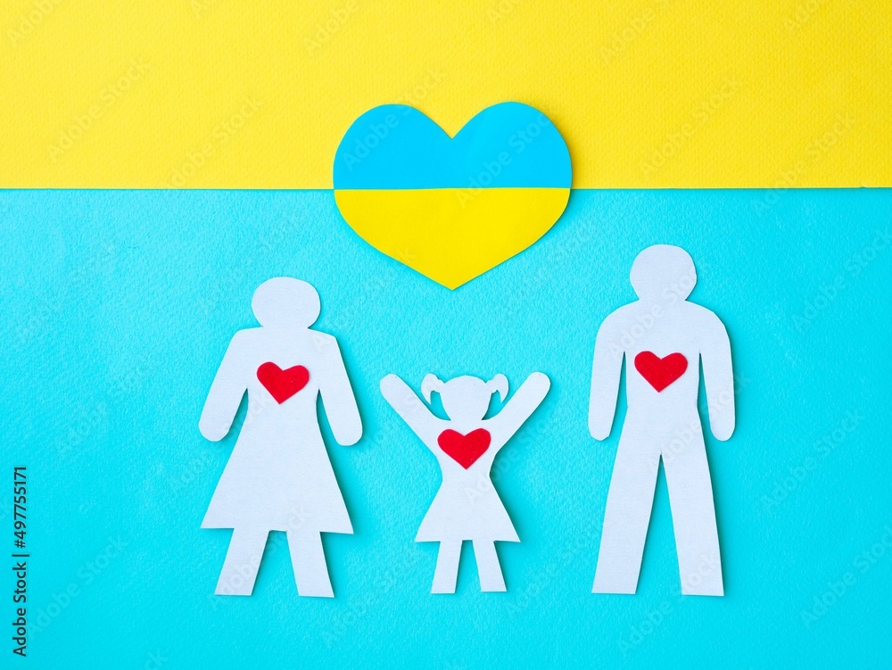 White silhouette of a family mom, dad and daughter with a red heart in the chest, the girl raised her hands up on blue. Heart in the color of the Ukrainian flag. Symbol of hope and salvation. White silhouette of a family mom, dad and daughter with a red heart in the chest, the girl raised her hands up on blue. Heart in the color of the Ukrainian flag. Symbol of hope and salvation.