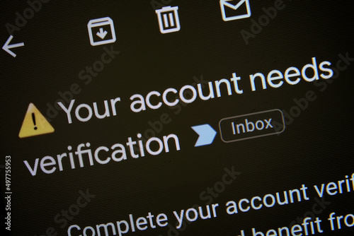 Email notification to verify new account opening in order to complete identity verification as part of KYC and AML policies. ID verification required for new crypto account. Phone screen, macro view.