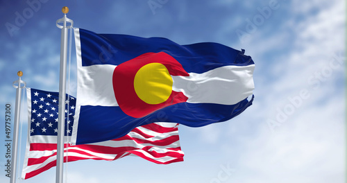 The Colorado state flag waving along with the national flag of the United States of America