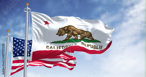 The California state flag waving along with the national flag of the United States of America