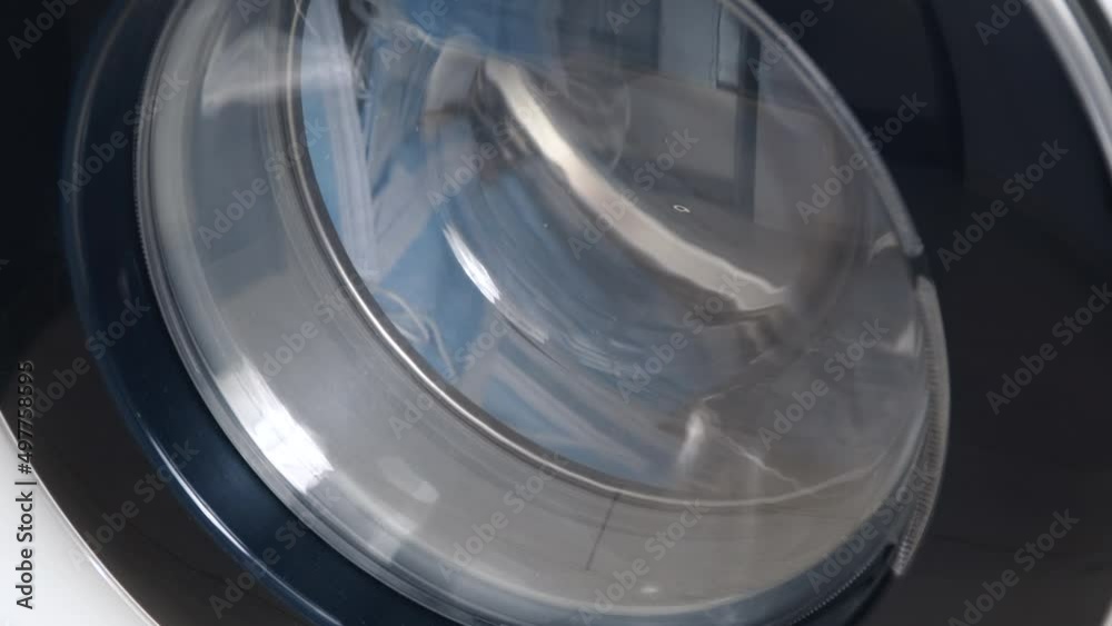 Washing machine washes dirty medical masks. Close up video of spinning drum washing machine Washing machine washes dirty medical masks. Close up video of spinning drum washing machine