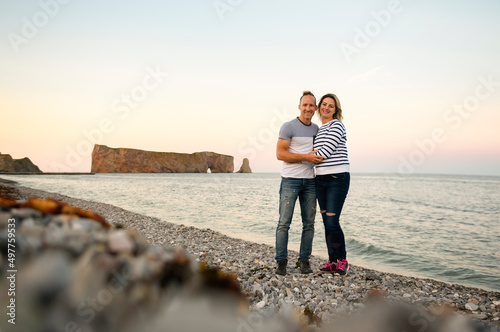 tourist couple enjoying Perce Rock view from Gaspe in Quebec photo