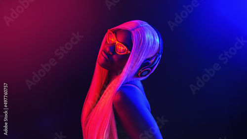 Photos Stylish fashion african teenager model wearing headphones listening dj music dancing in purple neon lights