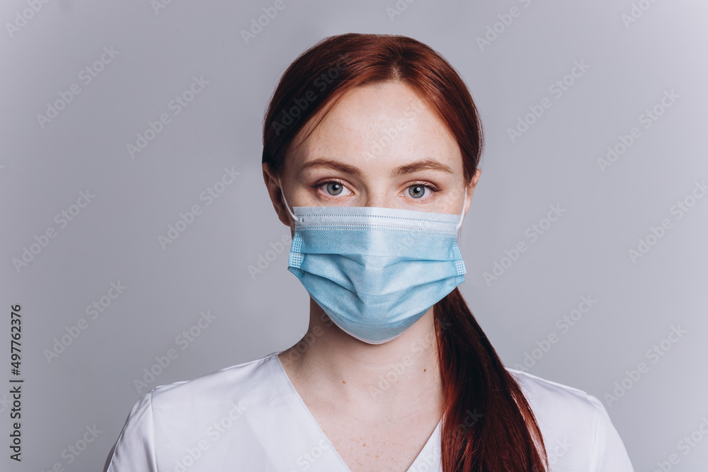 Woman doctor in medical mask on isolated background. Protection, epidemic, medicine, health care lifestyle concept Woman doctor in medical mask on isolated background. Protection, epidemic, medicine, health care lifestyle concept