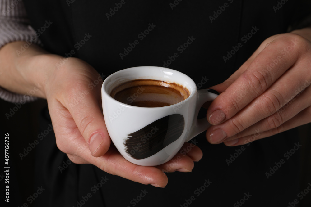 Woman holding cup of fresh aromatic espresso, closeup Woman holding cup of fresh aromatic espresso, closeup