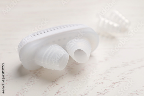 Anti-snoring device for nose on white wooden table, closeup