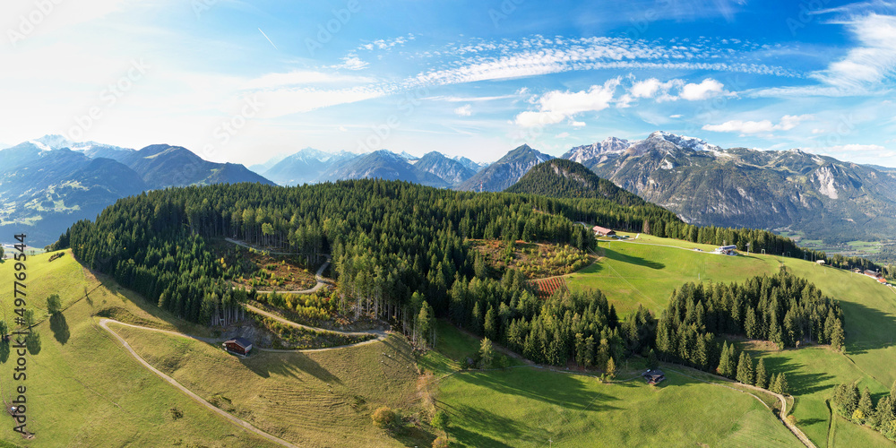 Aerial panorama of an alpine landscape in summer, with mountain meadows and green woods. Hiking vacation at Alpbach and Inntal valley in Tyrol, Austria.