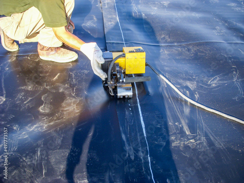 Fotografia, Obraz Joint between two HDPE liner sheets being hot welded together at a landfill expansion project