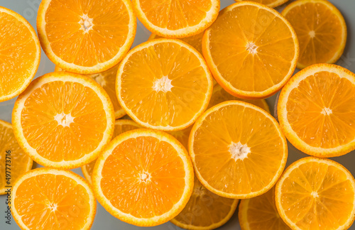 Orange slices on a light background. Juicy citrus fruits. Top view. Healthy natural product.
