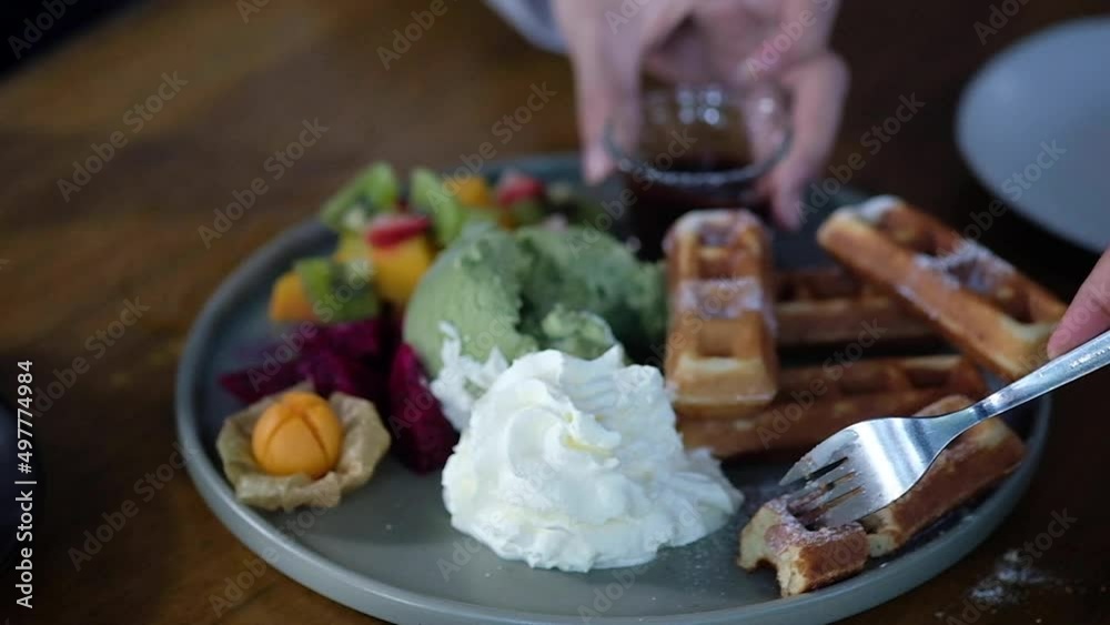 Belgian waffles with ice cream. Fork take bite of waffle. Slow motion. Belgian waffles with ice cream. Fork take bite of waffle. Slow motion.
