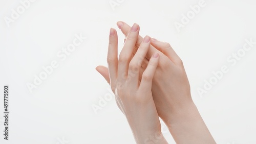 Close-up shot of smooth female hands on white background | Hand care commercial concept