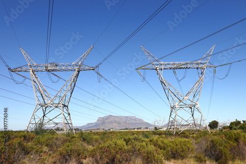 Electric pylons carrying high tension electric cables, near Cape Town in the Western Cape, South Africa.