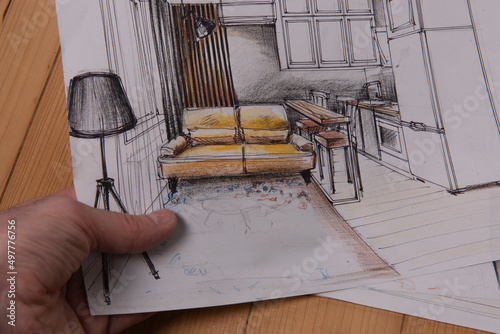 The photo shows sketches, a design project drawn with pencils on a piece of paper. Drawings, sketches, pencils, stationery on the table.
