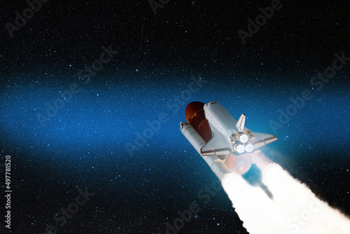 Fototapeta Naklejka Na Ścianę i Meble -  Spaceship lift off. Space shuttle with smoke and blast takes off into the starry sky. Rocket starts into space. Concept. Elements of this image furnished by NASA.