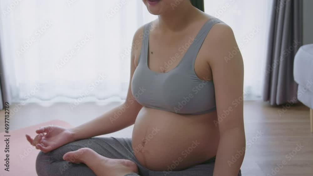 Young pregnant woman doing yoga at home, healthcare and pregnancy care concept Young pregnant woman doing yoga at home, healthcare and pregnancy care concept