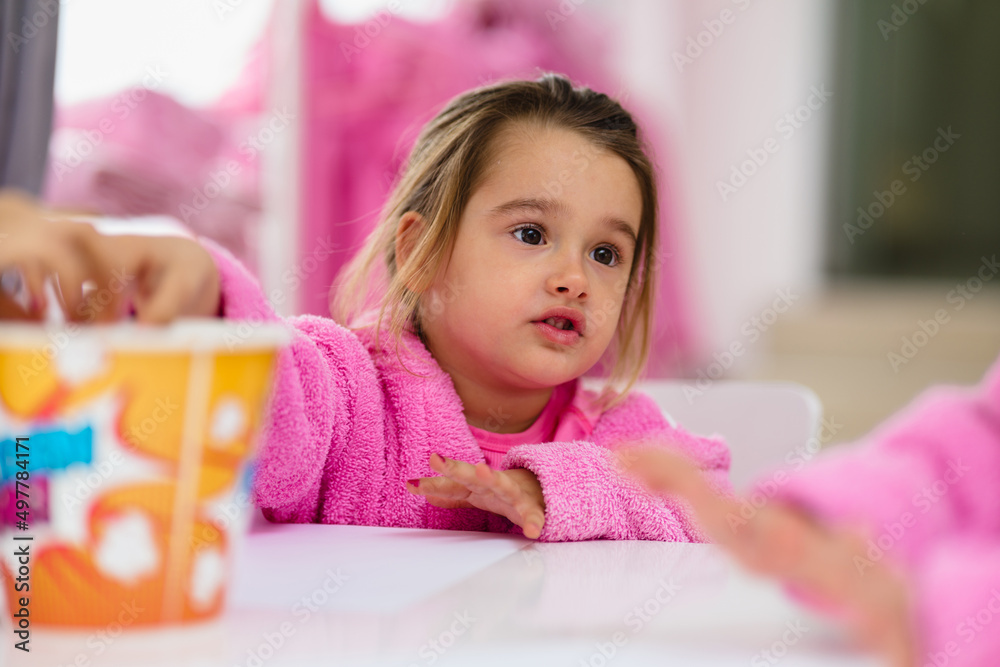 Little girls having fun in spa while drawing and eating popcorn. Little girls having fun in spa while drawing and eating popcorn.