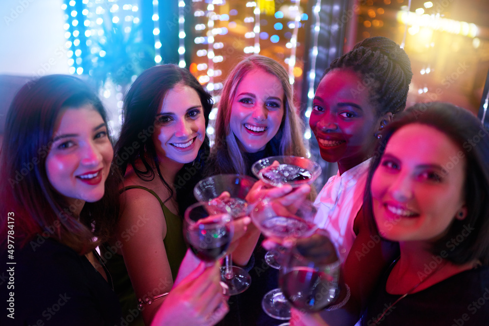 Getting the girls together for a memorable night out. Portrait of a group of young women drinking cocktails at a party.