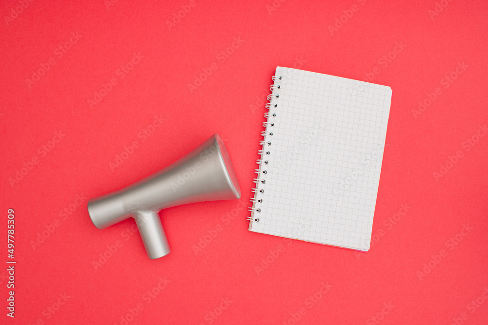 Megaphone A6 notebook wire binding mock up blank template design idea. Gray megaphone mockup against pastel pink background. Copy space templates designs for message layout. Megaphone A6 notebook wire binding mock up blank template design idea. Gray megaphone mockup against pastel pink background. Copy space templates designs for message layout.
