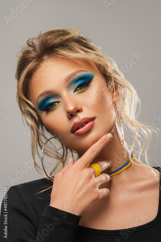 Beautiful blonde with blue-yellow make-up. Ukrainian girl with makeup