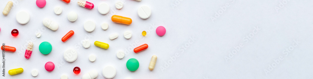 Many different pills on white background, flat lay.Global Pharmaceutical Industry and Medicinal Products - Colorful Pills, Tablets and Capsules, medicine and drug concept.web banner. Many different pills on white background, flat lay.Global Pharmaceutical Industry and Medicinal Products - Colorful Pills, Tablets and Capsules, medicine and drug concept.web banner.