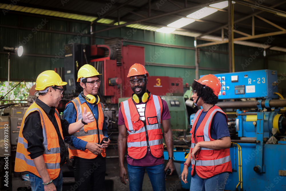 group of diversity teamwork, engineers, technician and workers team in safety uniform are happy morning talk before the start of work in heavy industrial manufacturer factory. group of diversity teamwork, engineers, technician and workers team in safety uniform are happy morning talk before the start of work in heavy industrial manufacturer factory.