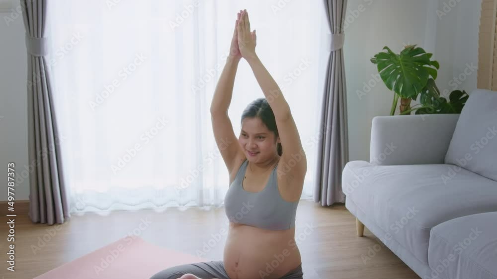Young pregnant woman doing yoga at home, healthcare and pregnancy care concept Young pregnant woman doing yoga at home, healthcare and pregnancy care concept
