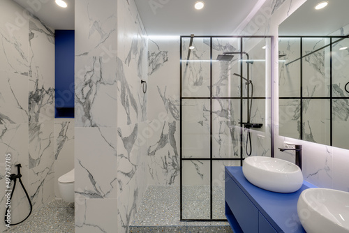 Modern bright bathroom with washbasins and large mirror with sub-heading photo