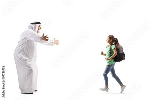 Full length profile shot of a schoolgirl running towards man in ethnic clothes